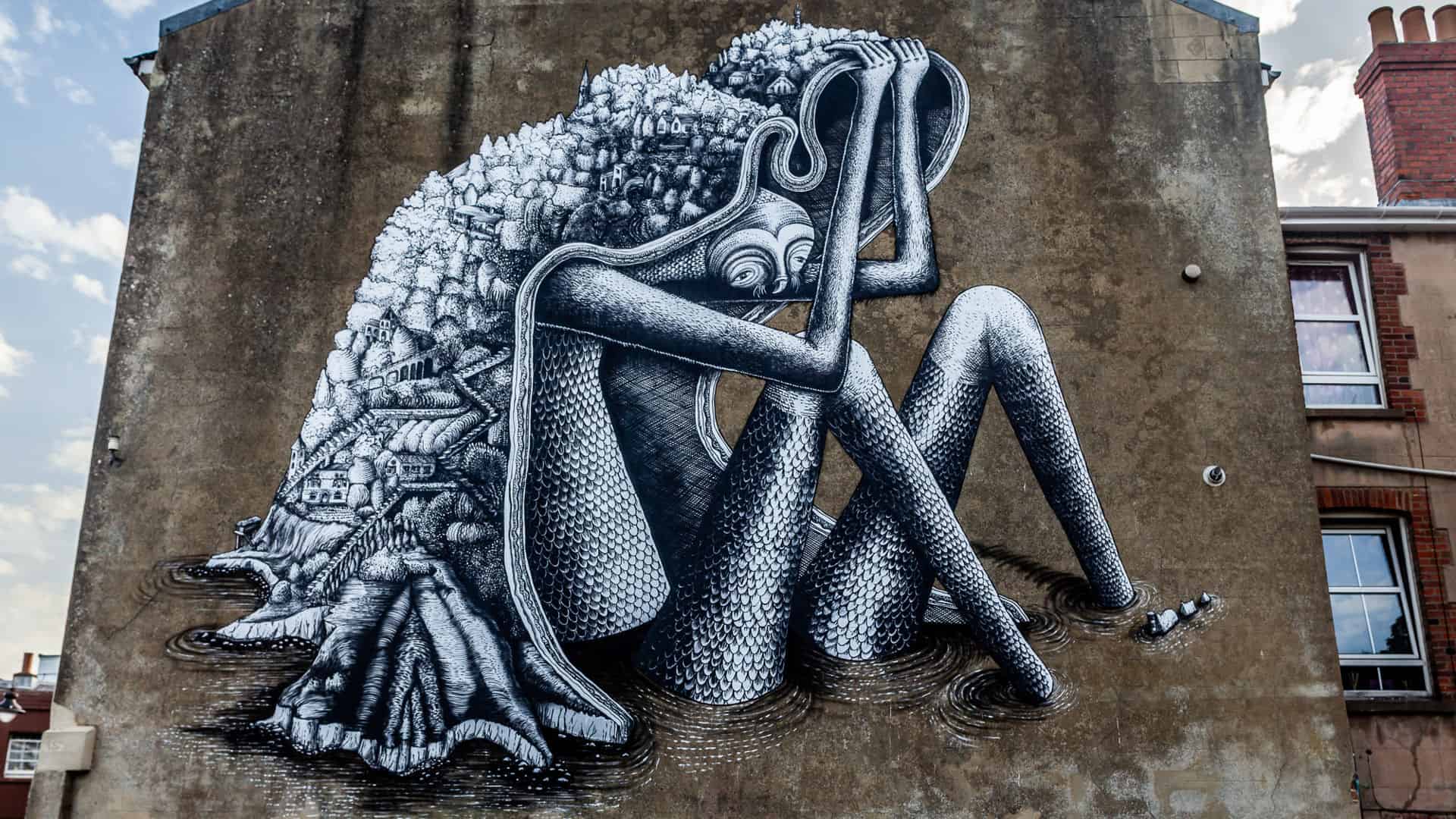 The Ventnor Giant Mural on side of a building by Phlegm