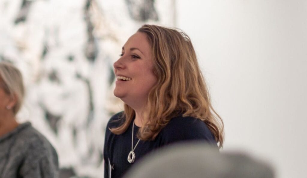 An image of Georgia Newman smiling at a workshop.