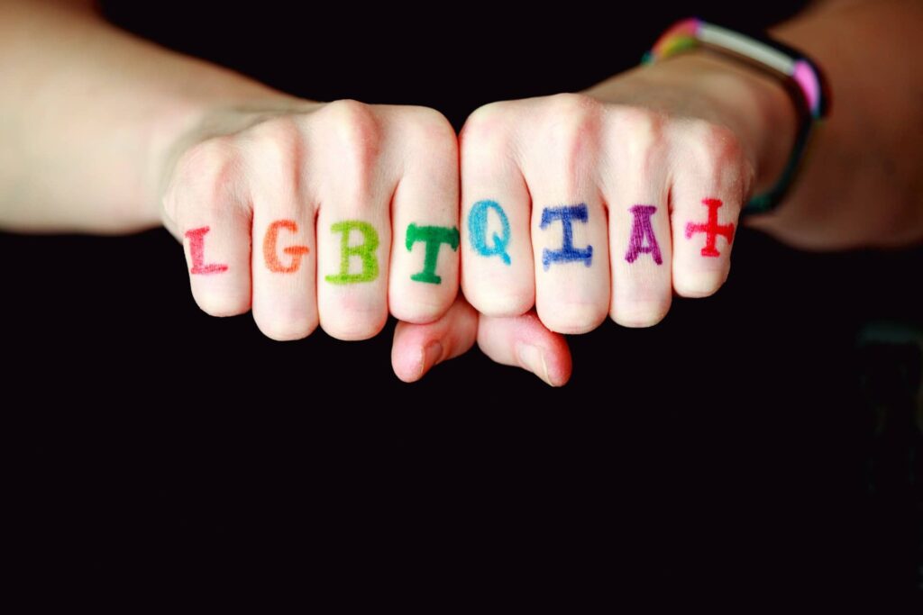 LGBTQIA+ written on knuckles of hands