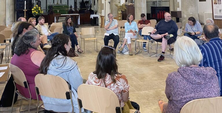 People sitting in the Newport Minster for Creative Newport's first meeting June 2024