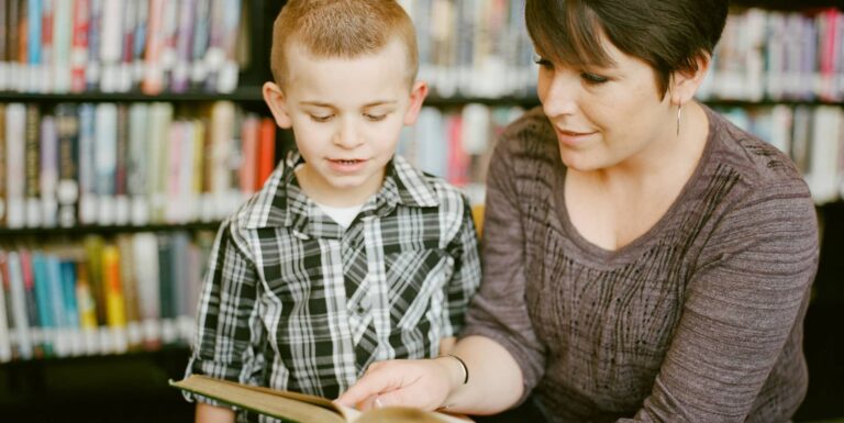 child being read to in library by woman