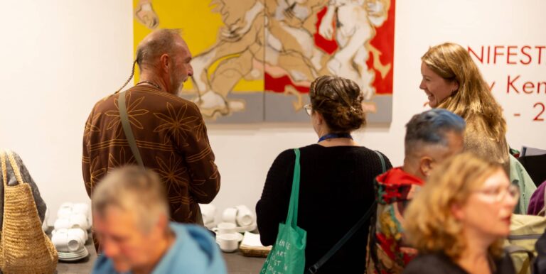 People gathering at the coffee and tea table