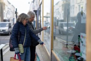 Two woman looking in the shop window