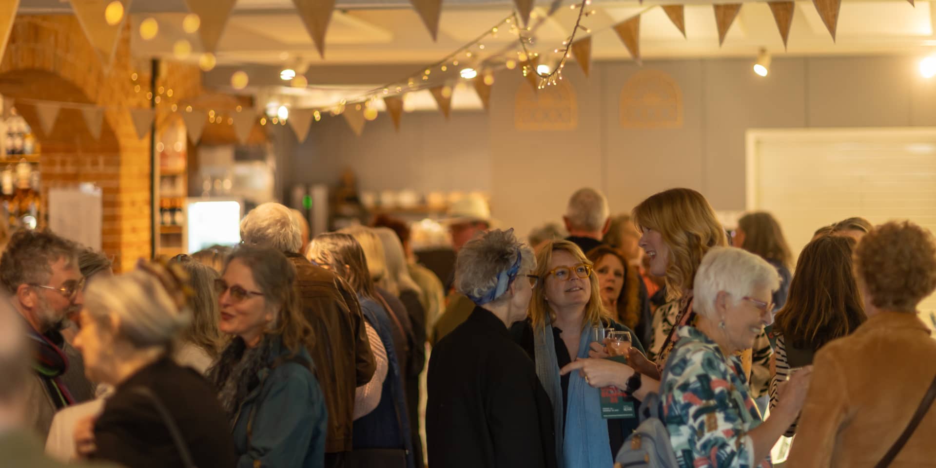 Visitors to the exhibition mingling in the cafe