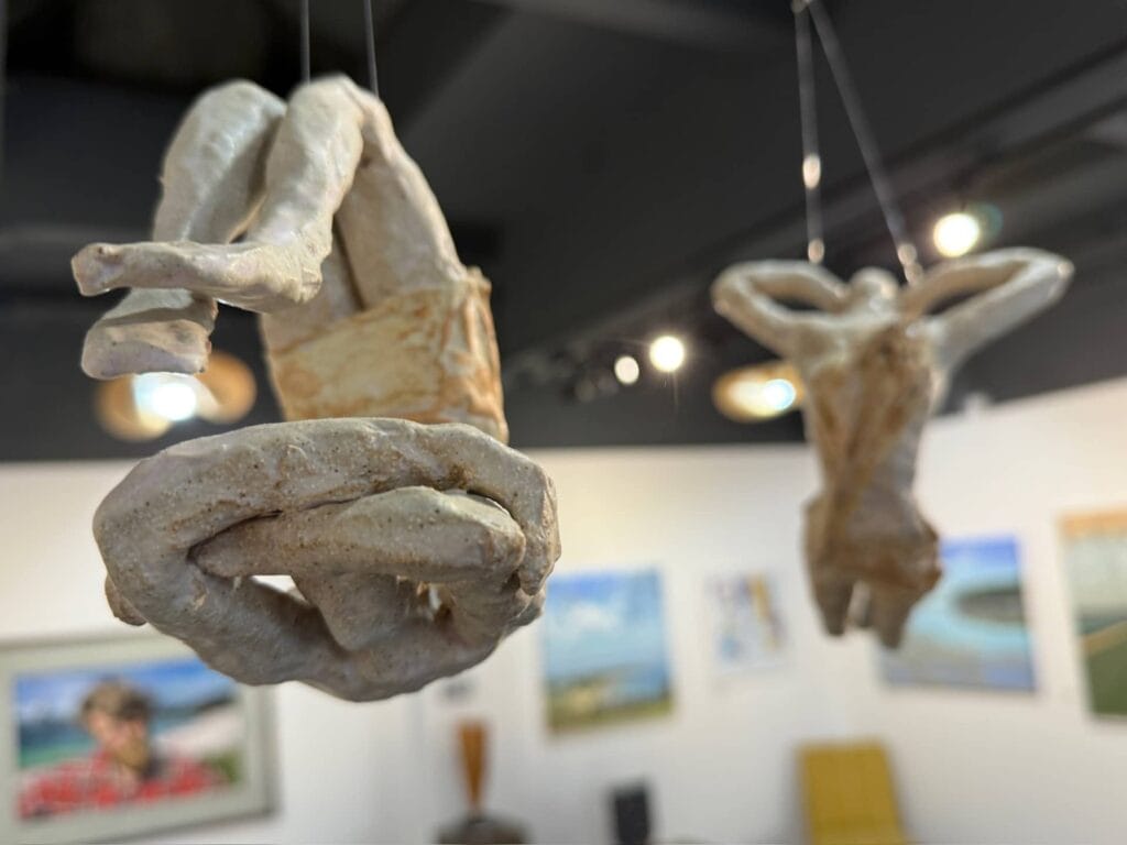 Ceramic acrobats sculpture by Gillian Clarke hanging from the ceiling at The Mead Gallery