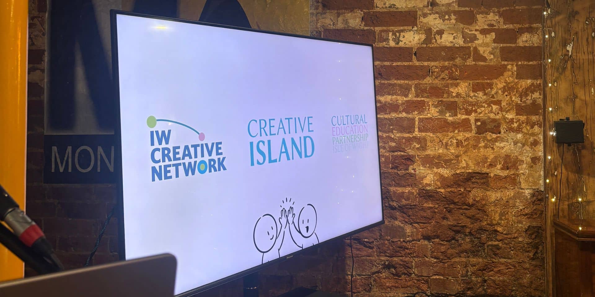 An image of a TV with IW Creative Network, Creative Island, and IW Cultural Education Partnership logos at Monkton Arts.