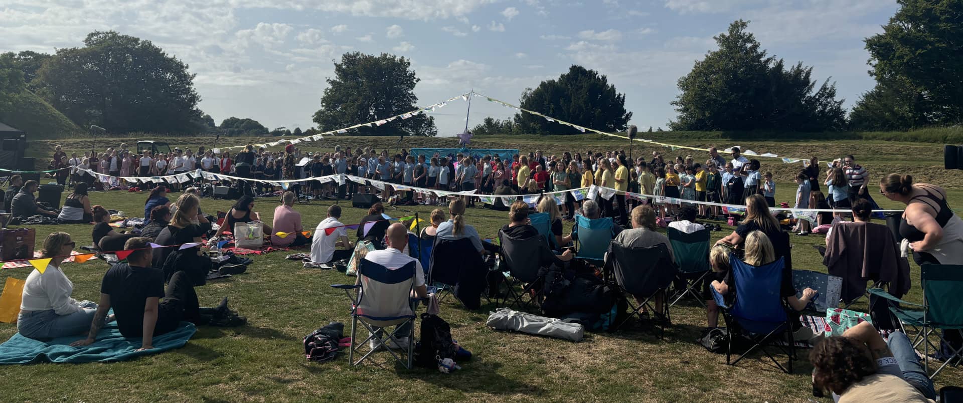 Our day will come event with lots of pupils on the grass at Carisbrooke Castle taking part in songs