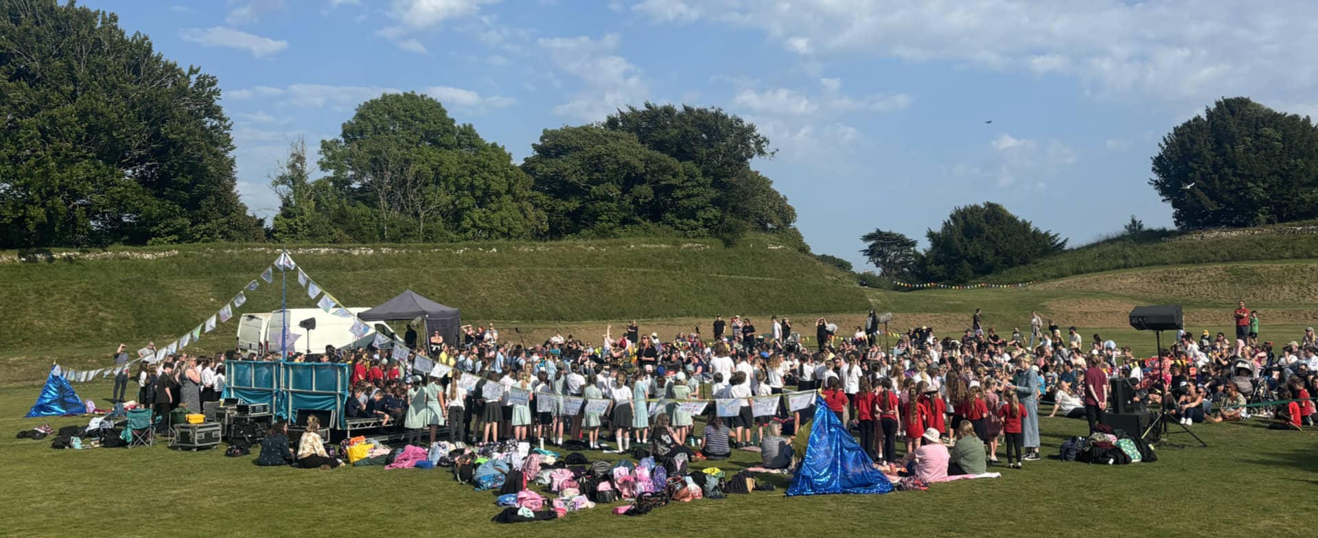 Our day will come event with lots of pupils on the grass at Carisbrooke Castle taking part in songs