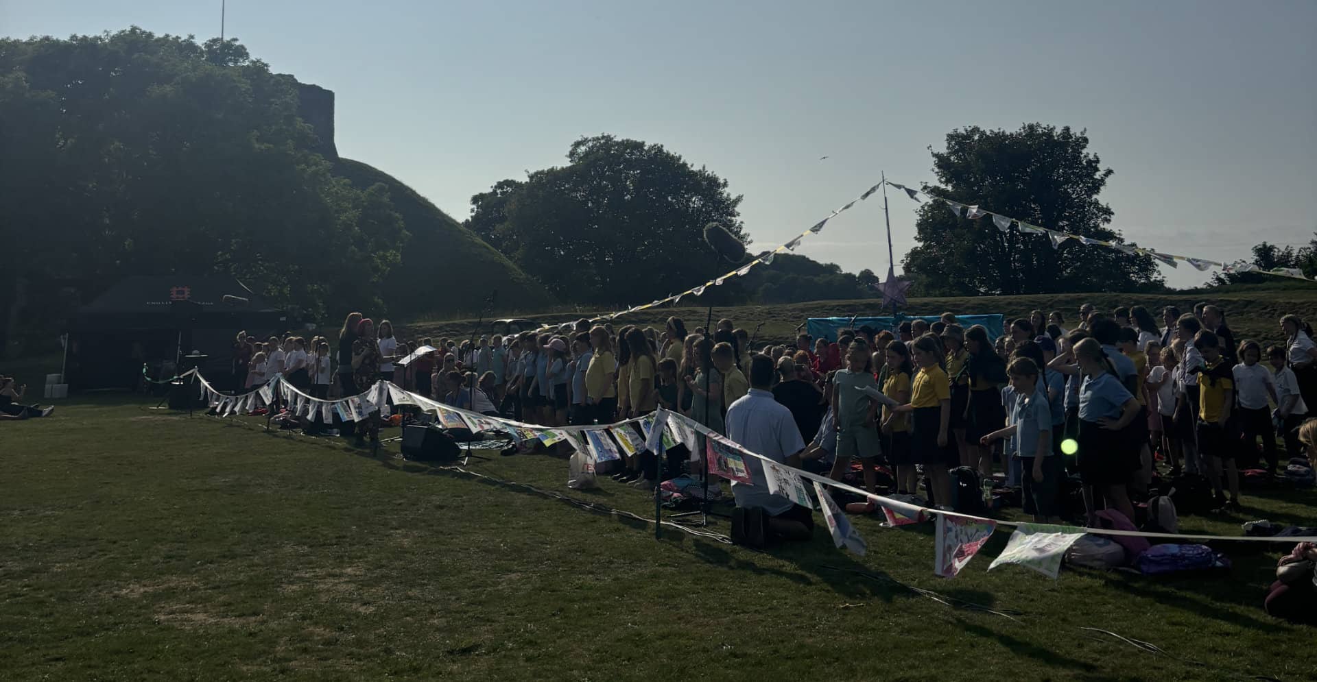 Our day will come event with lots of pupils on the grass at Carisbrooke Castle taking part in songs