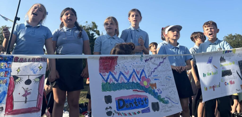 Our day will come event showing pupils singing and displaying their banners
