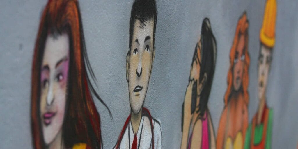 mural of young people on the wall of a external building