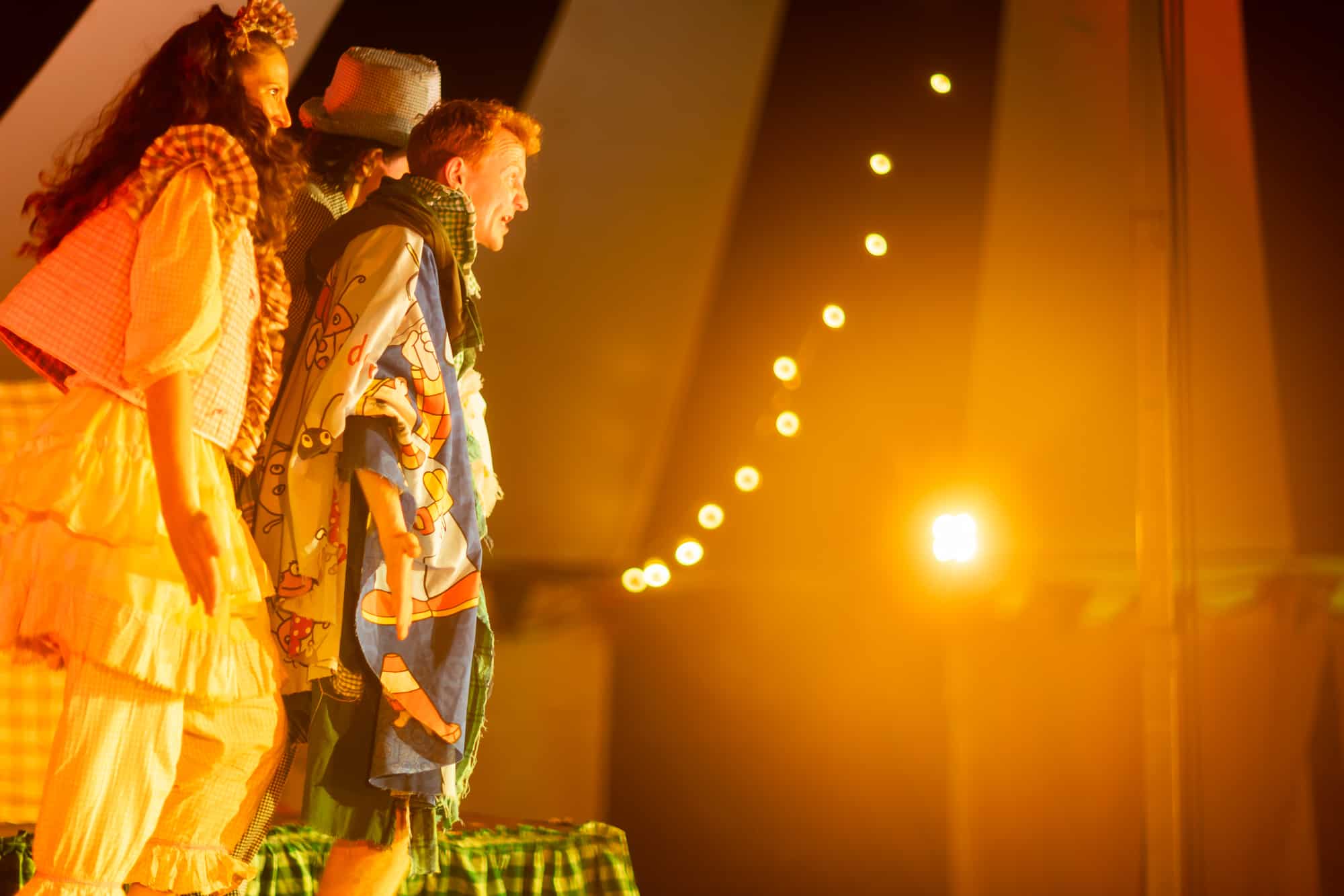 Performers on stage in theatrical costumes