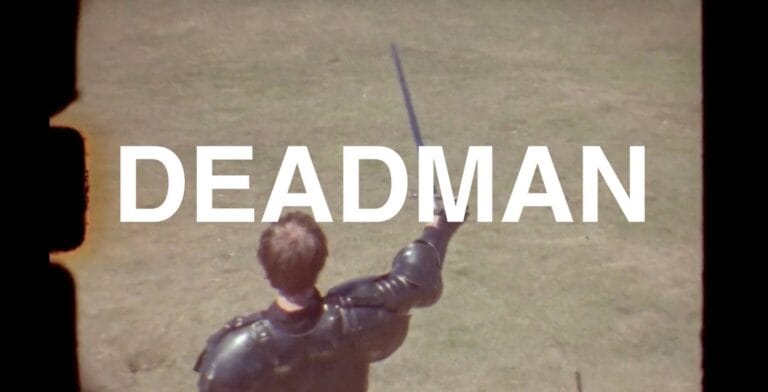 Grab of Film footage of a gladiator, with Deadman in large type overlaid on top