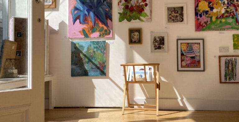 Photo of inside of Peer Studios in Ventnor, showing artwork on the walls and light coming in through the windows