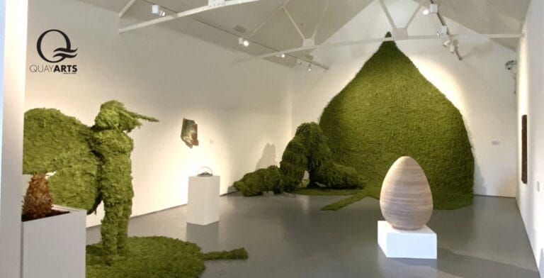 Exhibition at Quay Arts showing gallery space with lots of green exhibits