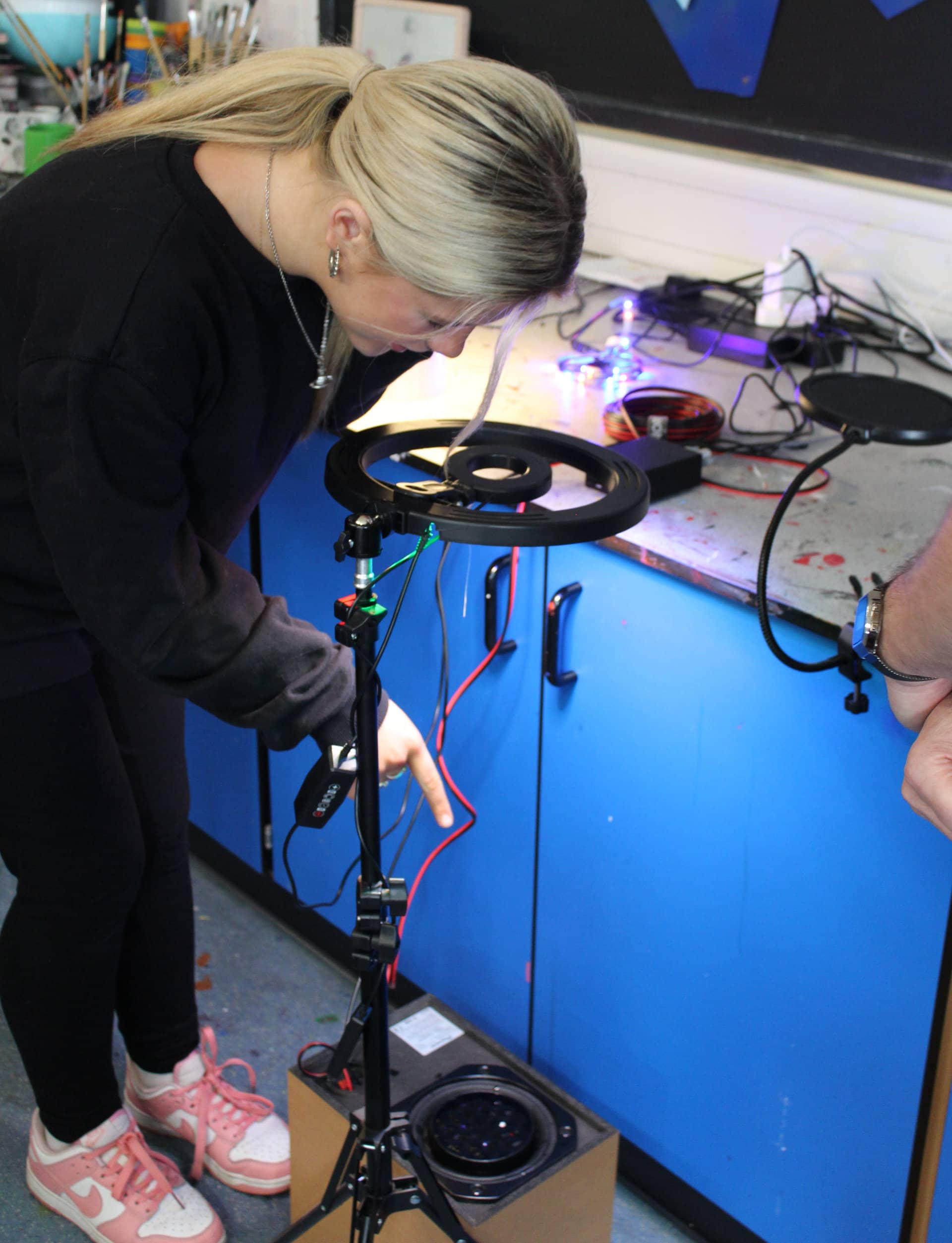 Student experimenting with cymatics