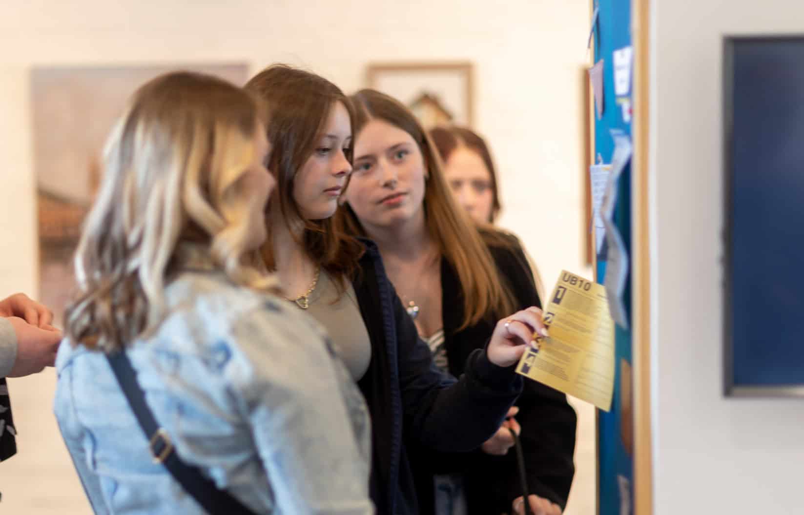 Young people looking at artworks