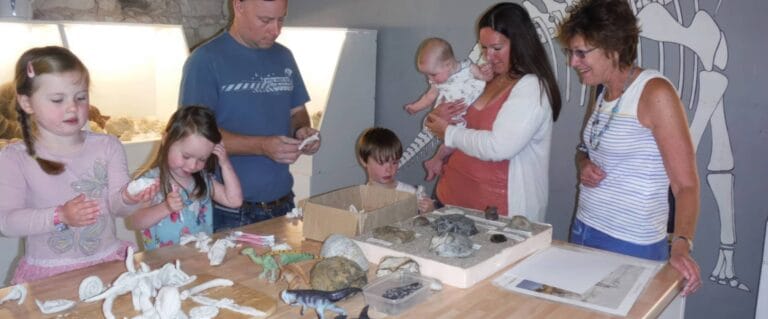 Family at the Dinosaur Expedition Centre looking at exhibits