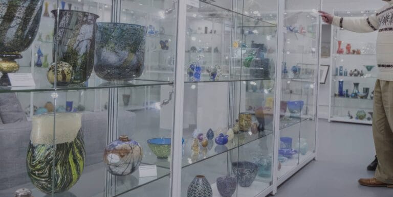 Glass cabinets displaying items inside the Isle of Wight Museum of Glass