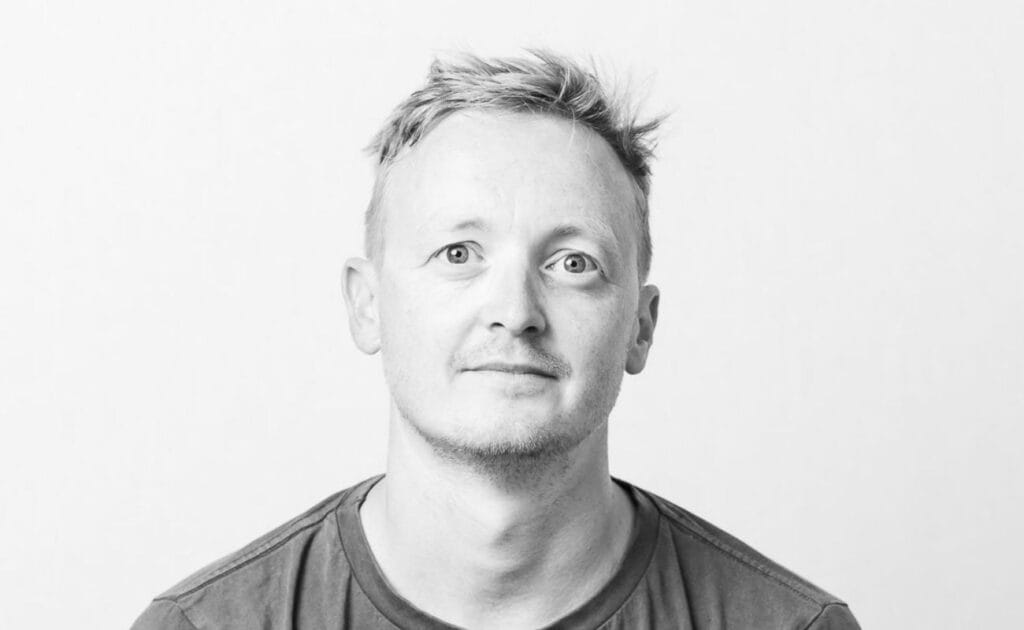 A close up image of Will Amery. Headshot style in black and white.