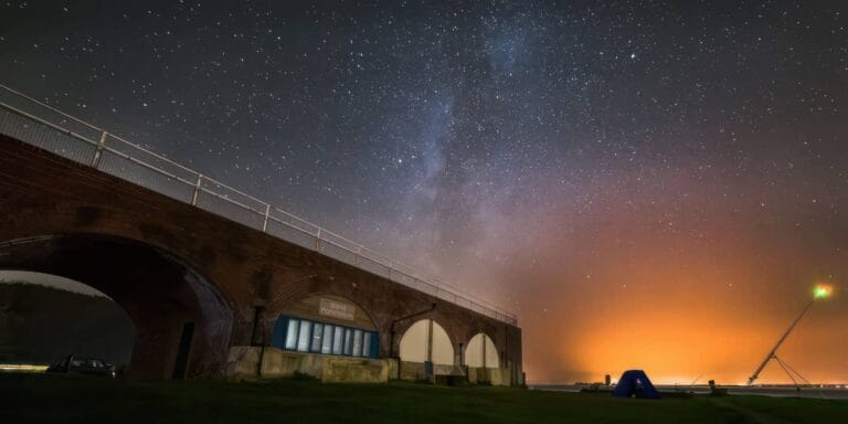 outside the Island Planetarium at night with milky way stars in the background