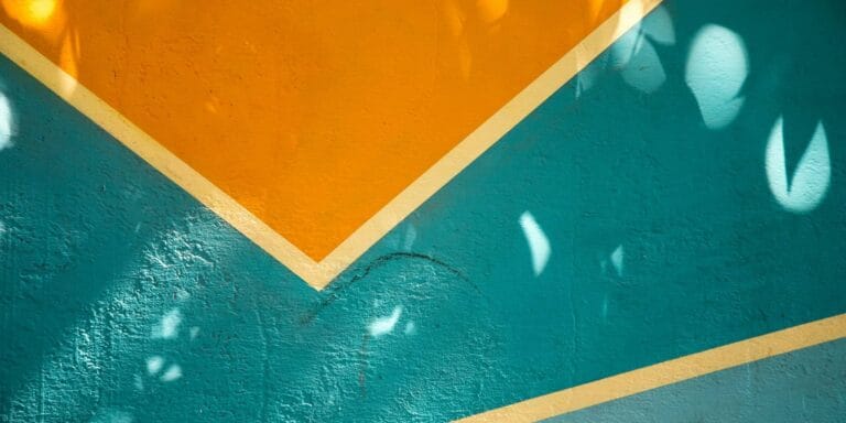 Blue and yellow mural on brick wall