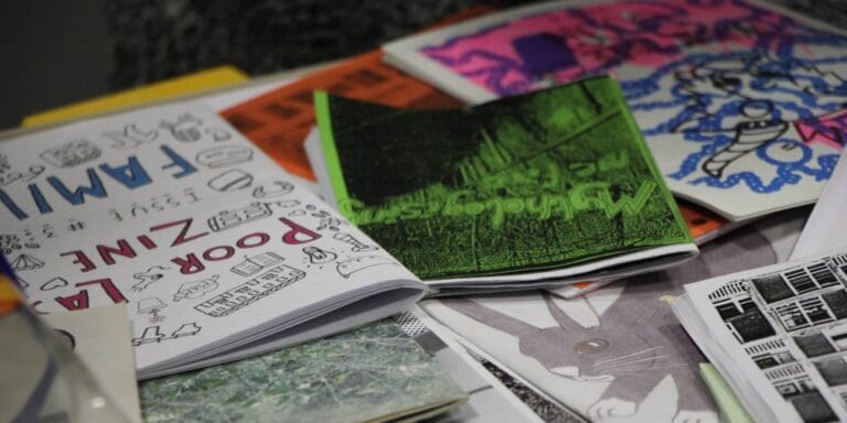 A tabletop covered with different zines
