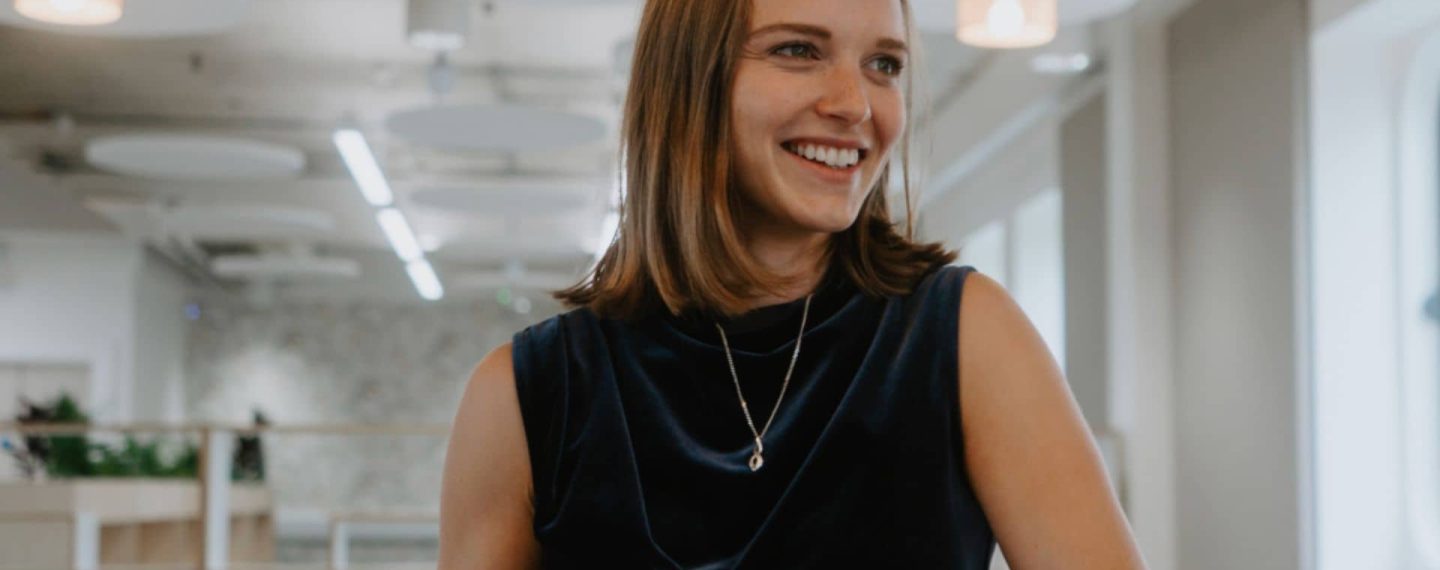 Ella Clapham from Isle of Wight Council's Regeneration team joins Creative Island's Board of Trustees. She's smiling with a cup of tea, and wearing a navy blue dress.